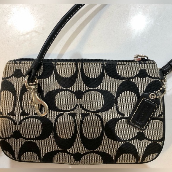 Coach Handbags - Coach Monogram Wristlet. NWOT. Excellent condition. Zipper Brown/ Camel colored